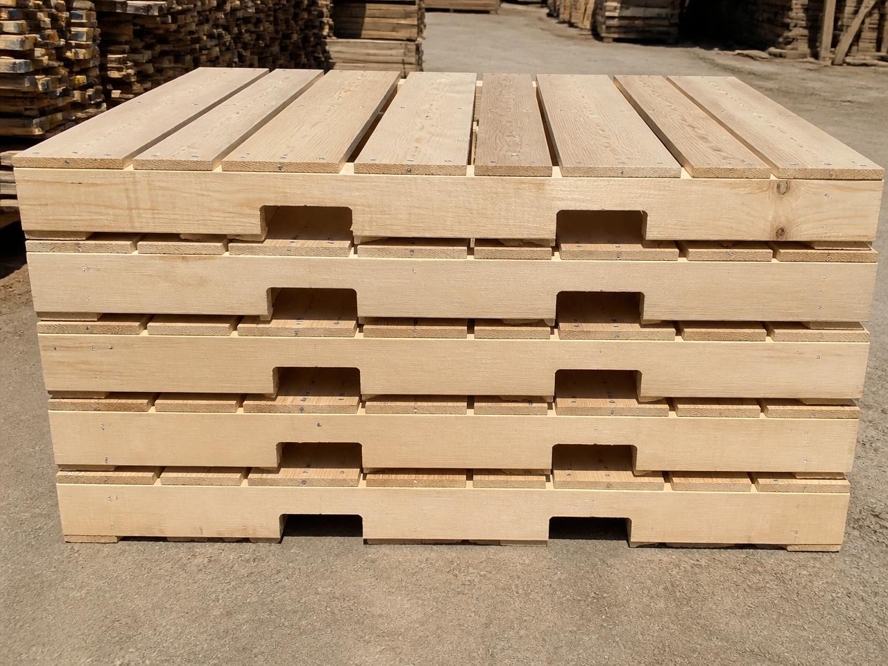 Stack of standard 48x40 GMA stringer pallets showing notched solid-sawn stringers and nailed deck boards